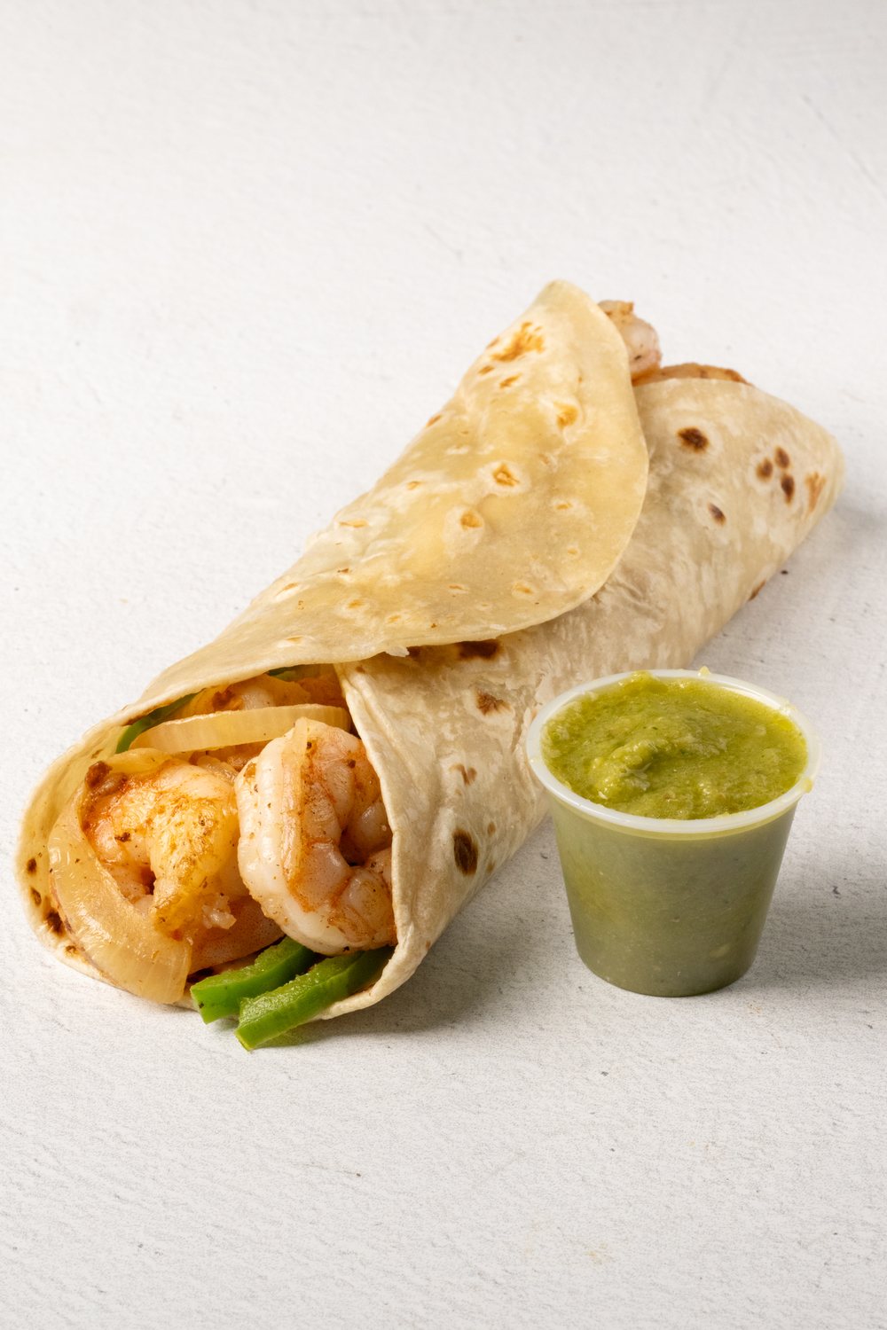 Shrimp wrap served with green salsa