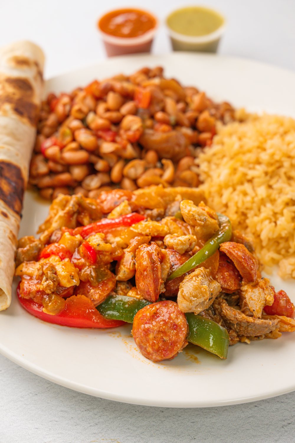Mixed grilled plate served with beans and rice