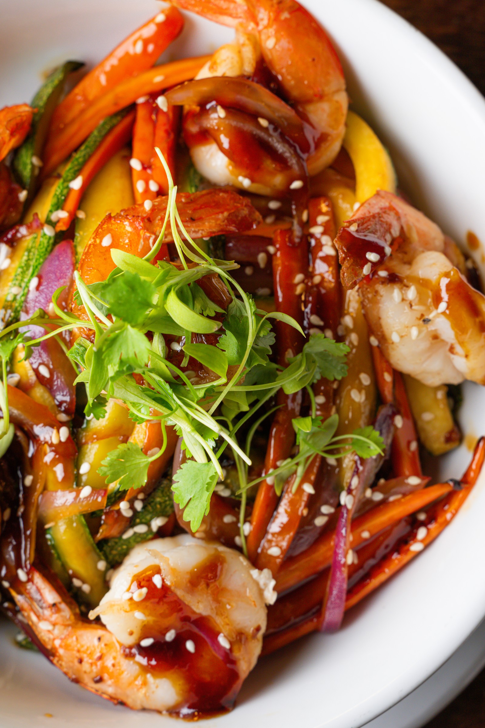 Seafood and vegetables with sauce, sesame, and herbs