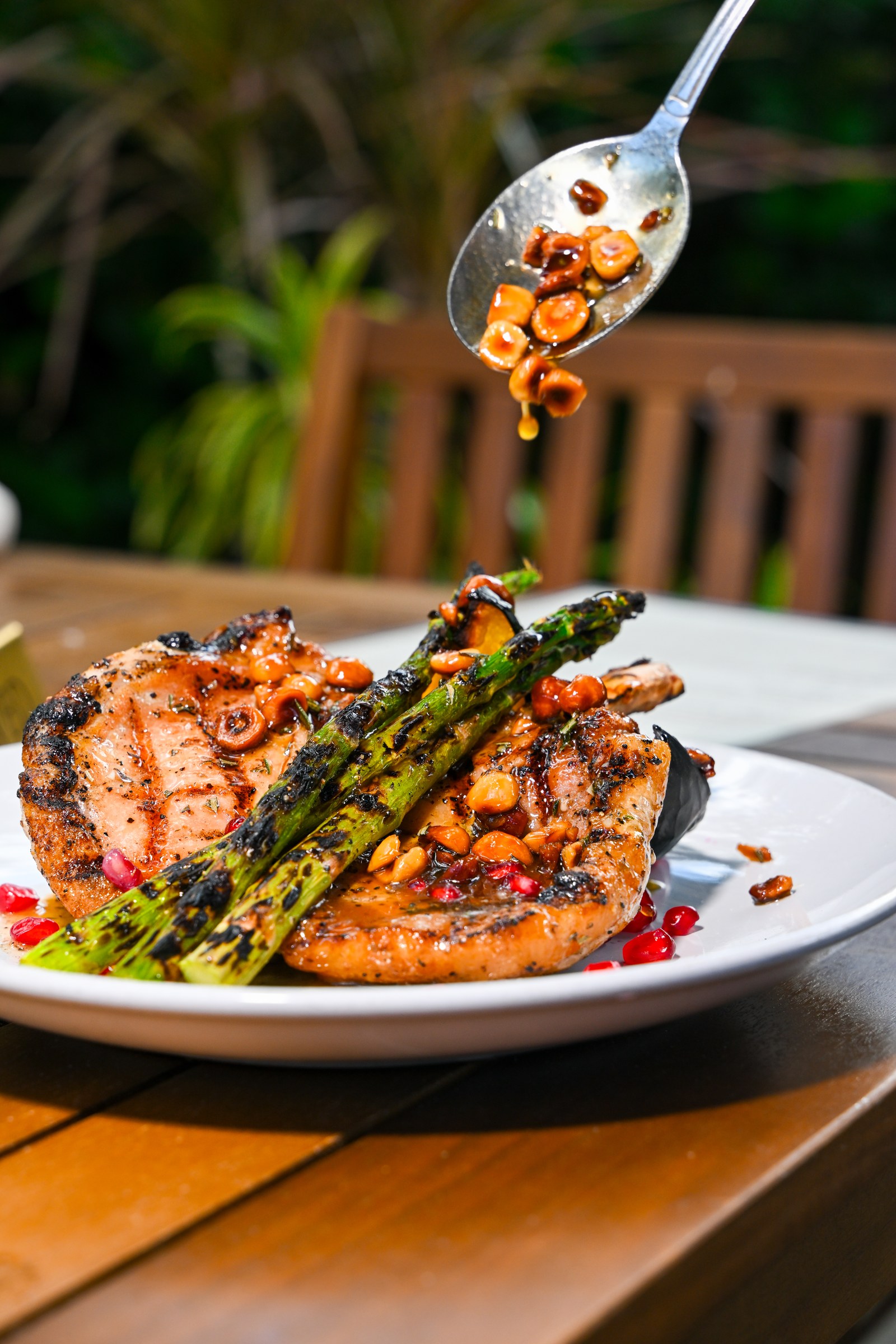 Grilled fish with asparagus and pomegranate garnish