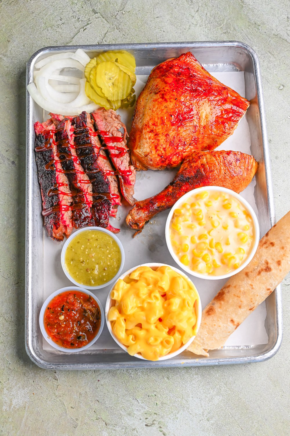 Ribs and smoked chicken with macaroni, beans, and bread